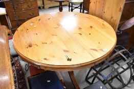 A vintage yellow pine circular extending dining table