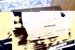 A vintage Singer sewing machine in dome top case