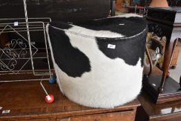 A novelty revolving stool, cow themed