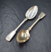 A pair of Victorian silver fiddle and thread pattern serving spoons, having heraldic crests to the