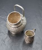 An Eastern white metal sugar bowl, of bulbous form having a rounded rim with a snake motif handle