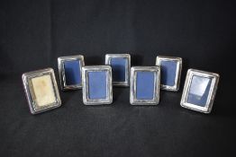 A group of seven silver mounted photograph frames, of rectangular form having bead thread decoration