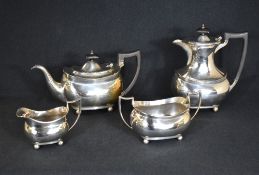 A George V silver four piece tea set, comprising coffee pot, teapot, sugar and cream, of oval