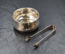 An Elizabeth II silver sugar bowl, of slight bulbous form having a moulded rim, raised on a small