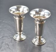 A pair of Elizabeth II silver vases, of fluted form having flared rims and banding to the body,