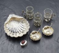 A pair of Victorian silver salts, in a shell motif raised on three ball feet with matching condiment