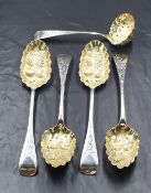 A cased set of four Victorian silver berry spoons, the Old English pattern serving spoons having
