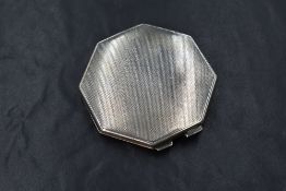 A George VI silver powder compact, of octagonal form having engine turned decoration, marks for