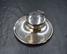 A George V silver inkwell and pen stand, of circular form having personalised engraving to the