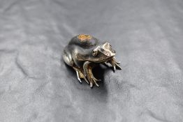 An Edwardian silver novelty pin cushion, modelled as a frog, having dark fabric to the body, marks