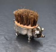 An Edwardian silver novelty pen wipe, modelled as a pig, having bristles to the back, marks for