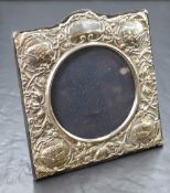 An Elizabeth II silver mounted photograph frame, of square form having embossed scroll and cherub