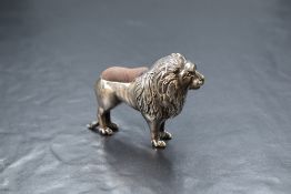An Edwardian silver novelty pin cushion, modelled as a lion, having dark fabric to the body, marks