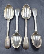A group of four William IV and Victorian silver fiddle and thread pattern serving spoons, having