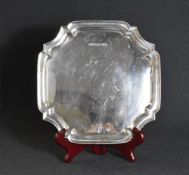 An Elizabeth II silver salver, of square form having a Chippendale style rim, raised on four