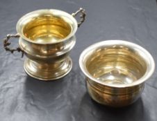 An Edwardian silver sugar bowl, of bulbous form having a flared rim and decorative scroll handles,