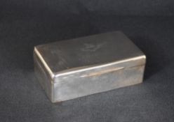 An early Edwardian silver cigarette box, of hinged rectangular form, having a heraldic crest and