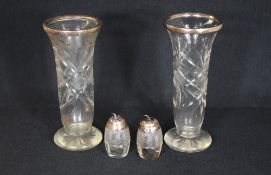 A pair of silver mounted cut glass vases, of fluted form with silver rims, along with a pair of