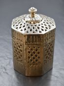An Eastern white metal Betel nut holder, of octagonal form having a moulded finial top with