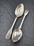 A pair of George III silver fiddle and thread pattern spoons, having heraldic crests to the