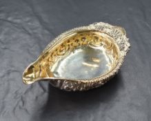 A late George III silver sauce boat, of traditional form having a narrow spout opposed by an