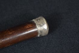 A George V silver mounted walking stick, the pommel being of plain form to the cane, marks for