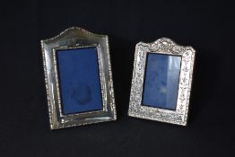 Two silver mounted photograph frames, of rectangular form one having a moulded bead thread border