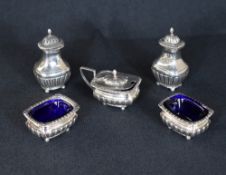 A set of Victorian silver condiments, comprising two salts and a mustard and two pepperettes, of
