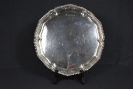 A George VI silver salver, of lobed circular form with a gadrooned rim, raised on three scroll feet,