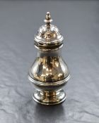 A Victorian silver sugar caster, the finial top of a circular bulbous body having step moulded