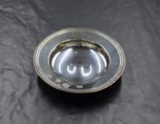 A boxed Elizabeth II silver 'Armada Dish' of circular form having engraved linework and slightly