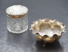 A small Eastern white metal bowl, having a crimped rim with lobed sections to the body, raised on