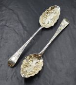 Two George III silver berry spoons, the Old English pattern serving spoons having later
