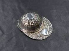 A George V silver caddy spoon, modelled as a jockey cap, having embossed decoration and a vacant