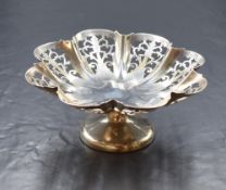 A George V silver pedestal dish, of lobed form having decorative pierced sides, raised on a circular