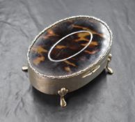 An early George V silver and tortoiseshell trinket box, the silver oval box having a tortoiseshell