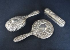 An Elizabeth II silver mounted vanity set, comprising a hair brush, clothes brush and hand mirror,