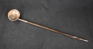 A George III white metal and baleen toddy ladle, of traditional form with baleen handle and coin