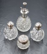 A pair of Victorian silver mounted moulded glass scent bottles, of circular form with a swirl design