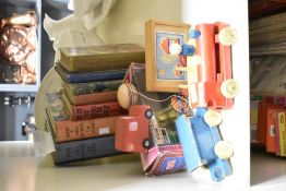 A group of wooden toy trains, sold together with a Boys and Girls book and a yo-yo ect, (14)