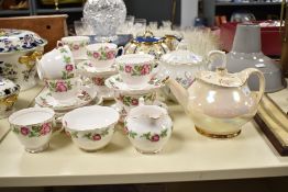 A Royal Vale bone china tea service having gilt edge and floral patterns, comprising of 9 cups, 7