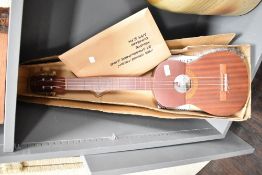 A traditional baritone ukulele and instruction book, h80cm
