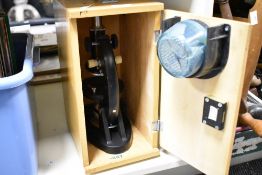 A microscope stored within a wooden box, h35cm
