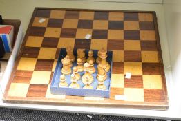 A wooden chess board with 16 chess pieces, 50.5cm x 50.5cm