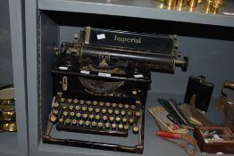 An early 20th century black Imperial type writer , the front reading, 'British Right Through',