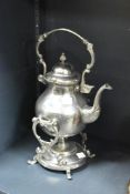 A silver-plated tilted tea pot having shaped spout and handle, h38