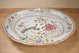 A Chinese Famille Rose dish of oval form decorated with double peacock and floral motifs, L40