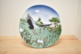 A ceramic plate decorated with stork/heron motif, w30.5cm