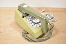 A two tone green vintage telephone having rotary dial, L19cm
