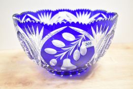 A glass bowl having hand cut geometrical patterns on a colbert blue ground, h16.5cm